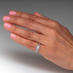 a woman's hand with a diamond ring on it