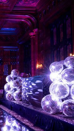 an elaborately decorated room with many shiny balls on the floor and lights in the ceiling