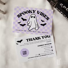 a thank you card with a ghost on it next to a black and white purse