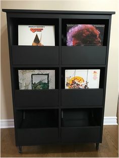 a black bookcase with four different pictures on it