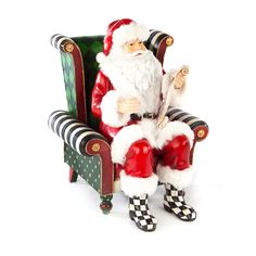 a santa clause sitting in a green chair with checkered socks and holding a pipe