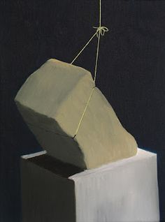 a painting of a rock on top of a block of white paper with a string attached to it