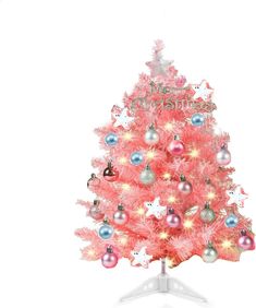 a pink christmas tree with ornaments on it and white base stands in front of a white background