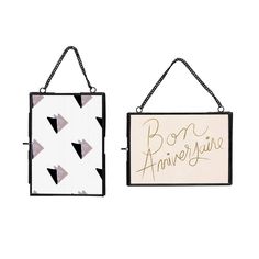 two black and white wall hangings that say, boo or anniverise on them