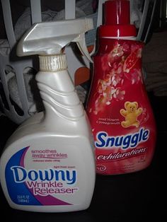 two bottles of downy and wrinkle release on a table