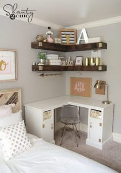 a white desk and shelves in a small room with a bed, chair and pictures on the wall