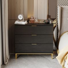 a black and gold chest of drawers next to a white bed with a clock on top