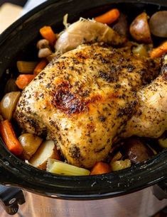 a close up of a chicken and vegetables in a crock pot with seasoning