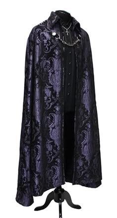 A magnificent cape fit for royalty. Made in rich flowing black and purple tapestry fabric with rich black satin lining inside. The high pointed collar can be worn down or up for an extra dramatic effect. Braided black trim lines the collar and along the front of cape. Fully lined in rich black satin. Fastens in front with a heavy antiqued chain which clasp at either side to heavy D-rings and decorated with two ornate metal buttons. Slits in the front of cape allow the wearer to reach through and Dark Purple Clothes, Black And Gold Outfit, Purple Tapestry, Black Tapestry, Prince Clothes, Adventure Outfit, Period Outfit, Tapestry Fabric, Fashion Suits For Men