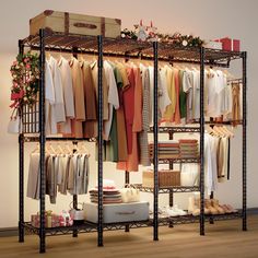 a clothing rack with clothes and other items on it in a room filled with wooden floors