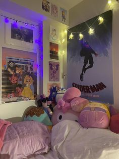 a bedroom with stuffed animals and posters on the wall