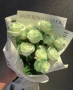 a person holding a bouquet of white roses