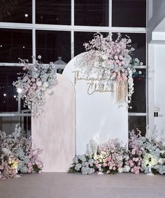 an entrance decorated with pink and white flowers