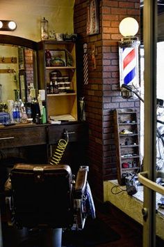 a barber shop with an old fashioned bicycle parked in front of the mirror and brick wall