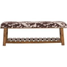 a wooden bench with a cow print upholstered cushion on it's back