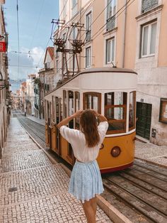 a woman standing in front of a trolley car