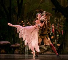 a man and woman in costume dancing on stage