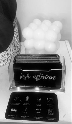 black and white photograph of business cards on table with hat, vase and other items