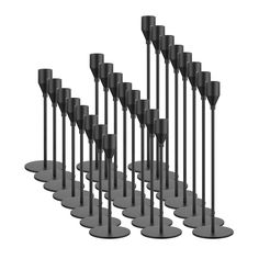 a set of eight black candles sitting next to each other on top of metal bases