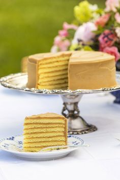 two pieces of cake sitting on plates next to each other with flowers in the background