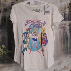 New With Tags! Sailor Moon Crystal Guardians Sparkly Lettering Girls Medium Graphic T-Shirt. Crafted From Lightweight Jersey Fabric, This Short-Sleeve T-Shirt Offers All-Day Comfortable Wear. Designed In A Cream Hue, This Crewneck Tee Features A Graphic Of The Sailor Moon Crystal Guardians Season Three Poster Featuring Sailor Moon And The Other Guardians For A Fan-Favorite Look. Cotton And Polyester Blend. Bundle With Some Of My Other Girls Items To Save More And Pay Only One Shipping! Kawaii Cotton Tops With Character Print, Cotton Anime Print Crew Neck Top, Anime Print Cotton Crew Neck Top, Cotton Anime Print Short Sleeve Top, Short Sleeve Cotton Top With Anime Print, Cotton Short Sleeve Top With Anime Print, Multicolor Cotton Anime Print Tops, White Cotton Anime Print Top, Multicolor Kawaii Tops With Letter Print