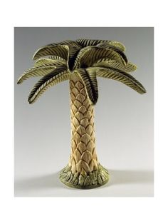 a ceramic palm tree is shown on a white background