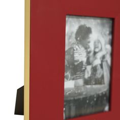 a red frame with a black and white photo in it