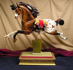 a statue of a horse that is jumping in the air