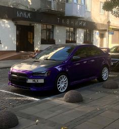 a purple car parked in front of a building