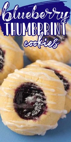 blueberry thumbprint cookies with white icing on a blue background and text overlay