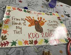 a child's handprinted thanksgiving card on a table