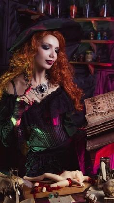 a woman with red hair is dressed as a witch