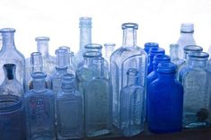 there are many empty glass bottles lined up