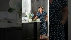 a woman standing in a kitchen next to a counter with flowers and vases on it