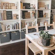 a dining room table and chairs with bookshelves in the backgroung