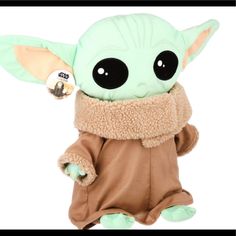 a baby yoda stuffed animal with a scarf around it's neck and eyes