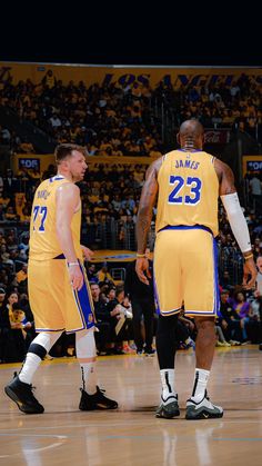 two basketball players are standing on the court