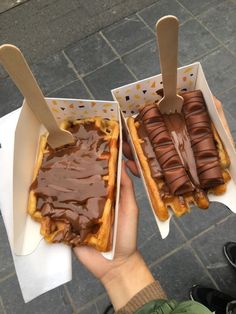 two waffles with chocolate frosting and spoons in them