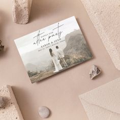 a couple standing next to each other in front of some rocks and paper with the words save the date on it