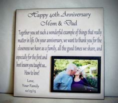 an anniversary gift for mom and dad is shown with a photo on the wall behind it