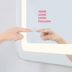 two hands pointing at each other in front of a mirror that says 300k 4200k 64, 000k dimmable