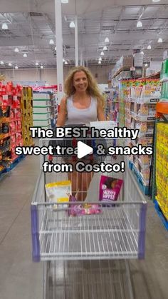 a woman is pushing a shopping cart in a store with the words, the best healthy sweet treats & snacks from costco