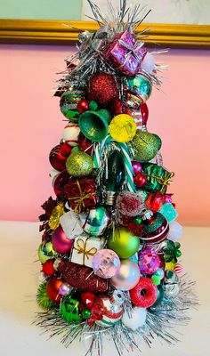 a christmas tree made out of ornaments and tinsel