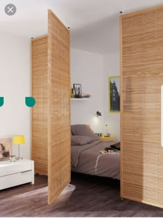 a bedroom with wooden slats on the walls and a bed in the corner between two doors