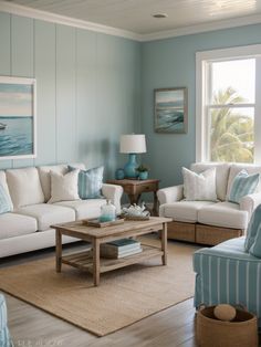 a living room with blue walls and white furniture