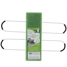 three green sponges with black handles on each side and two white pins in the middle