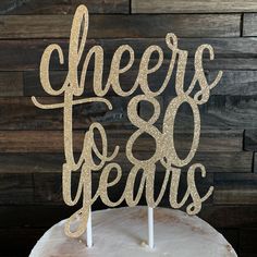 a cake topper that says cheers and years on it