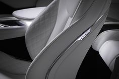 the interior of a luxury car with white leather