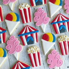 some decorated cookies are on a white wooden table with red, white and blue icing