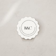 a white label with the words r & c on it